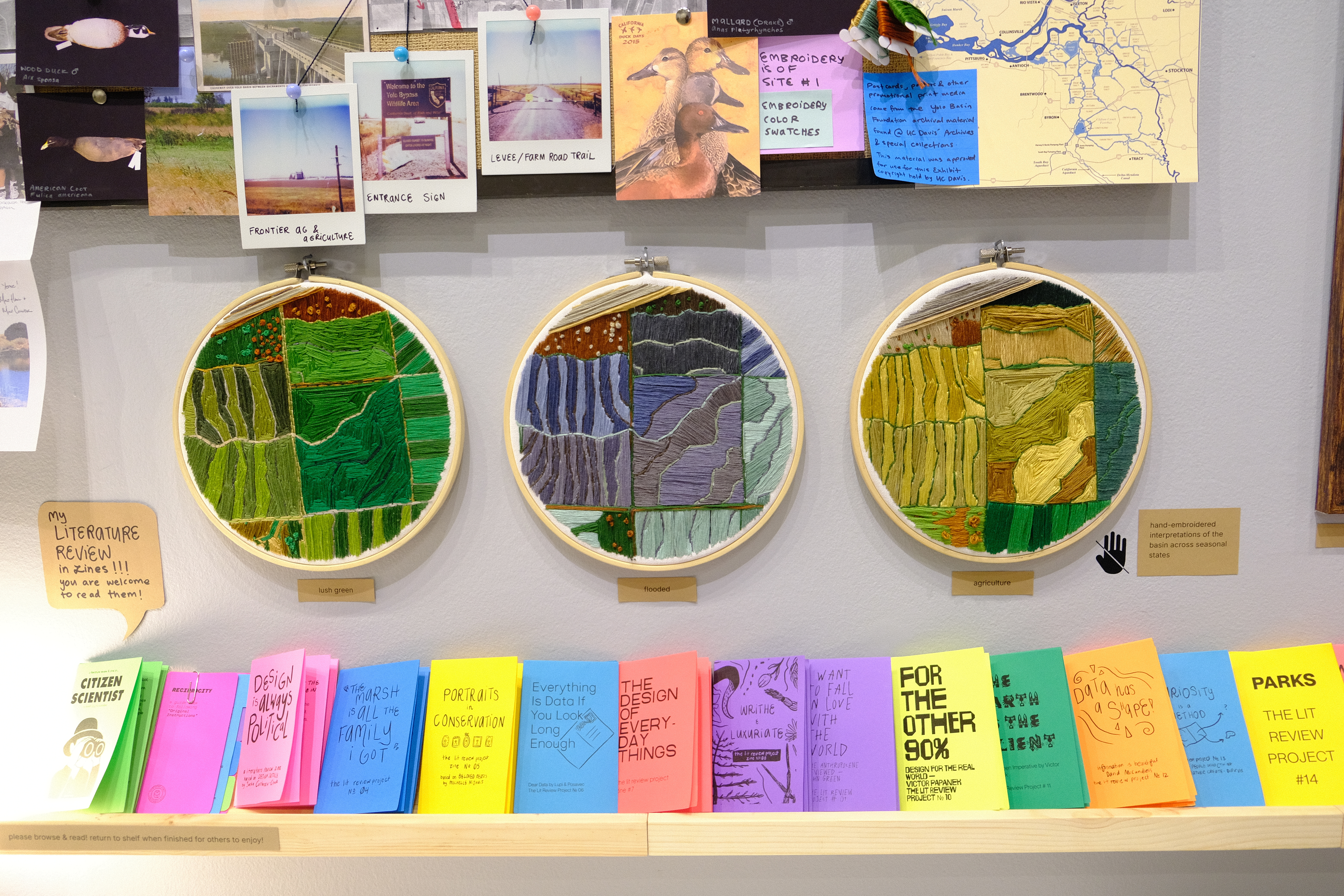 the embroidery hoops and lit review zine shelf